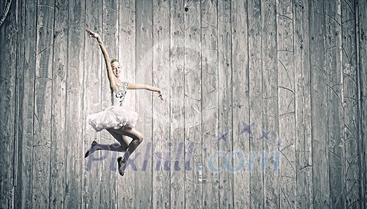 Young pretty ballerina girl making jump in dance Young pretty ballerina girl making jump in dance