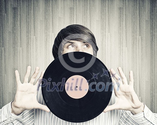 Young handsome man dj holding disco plate Young handsome man dj holding disco plate