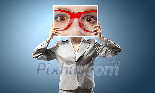 Unrecognizable businesswoman holding big photo with eyes Unrecognizable businesswoman holding big photo with eyes