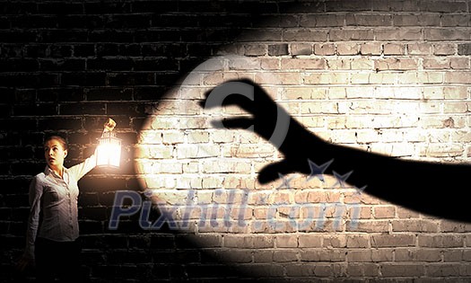 Young pretty businesswoman with lantern in darkness Young pretty businesswoman with lantern in darkness