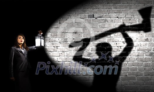 Young pretty businesswoman with lantern in darkness Young pretty businesswoman with lantern in darkness