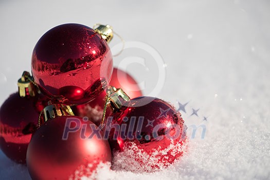christmas red balls decoration in fresh snow background on beautiful sunny winter day christmas red balls decoration in fresh snow background on beautiful sunny winter day