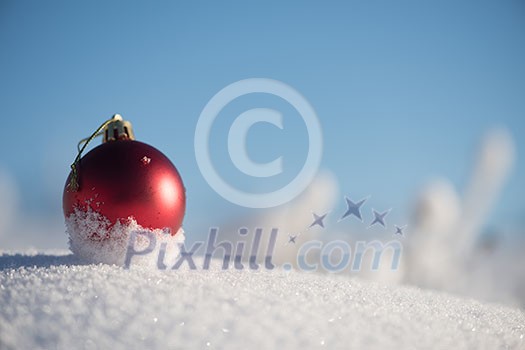 christmas red balls with long shadows in fresh snow on beautiful sunny winter day christmas red balls with long shadows in fresh snow on beautiful sunny winter day