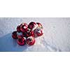 christmas red balls with long shadows  in fresh snow on beautiful sunny winter day