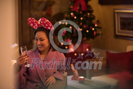 people, and relaxation concept beautiful young woman in bath robe drinking champagne at spa over holidays lights background people, and relaxation concept beautiful young woman in bath robe drinking champagne at spa over holidays lights background