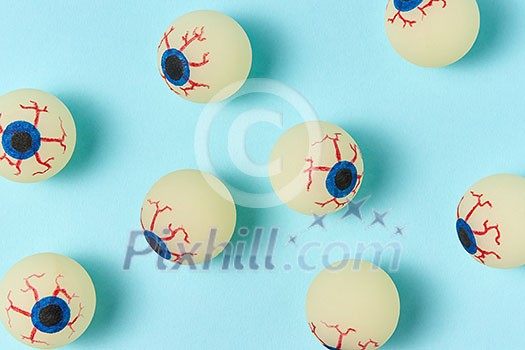 Simbol of Halloween big eyeballs with soft shadows on a light blue background. Simbol of Halloween big eyeballs with soft shadows on a light blue background.