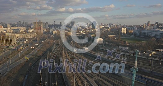 Railway with passing trains and view of the modern city against the sky. 4K video, 240fps, 2160p. Railway with passing trains and view of the modern city against the sky. 4K video, 240fps, 2160p.