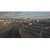 Railway with passing trains and view of the modern city against the sky. 4K video, 240fps, 2160p.