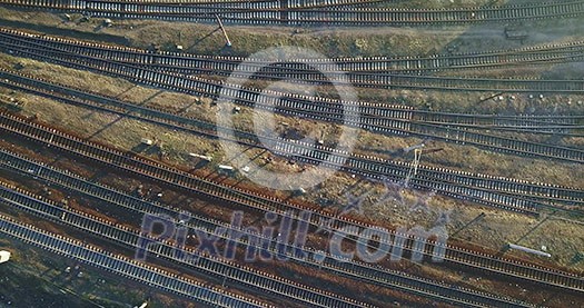 Intersecting rails of railways with carriages of trains near the road with a passing car. 4K video, 240fps, 2160p.