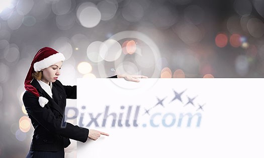 Santa woman pointing with finger at blank banner. Place for your text Santa woman pointing with finger at blank banner. Place for your text