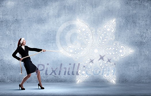 Santa woman pulling white snowflake on rope Santa woman pulling white snowflake on rope