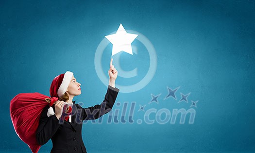 Woman in formal suit and Santa hat with red bag. Mixed media Woman in formal suit and Santa hat with red bag. Mixed media