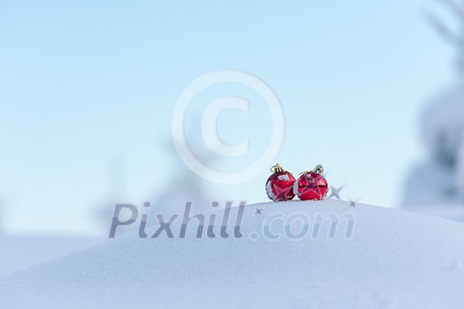 christmas red balls with long shadows in fresh snow on beautiful sunny winter day christmas red balls with long shadows in fresh snow on beautiful sunny winter day