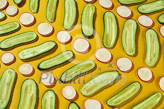 Fresh ripe radish, cucumber - ingredients for cookind dieting vegetarian food on a yellow background. Vegan food ceometric background. Top view. Fresh ripe radish, cucumber - ingredients for cookind dieting vegetarian food on a yellow background. Vegan food ceometric background. Top view.