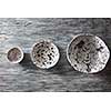 Traditional souvenir ceramic handcrafted plates and bowls on a concrete background with place under text. Flat lay.