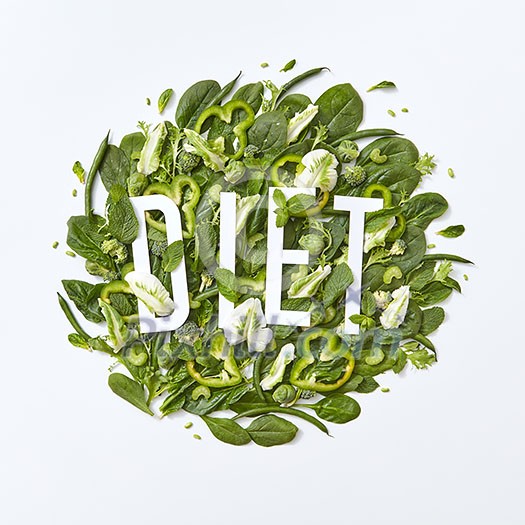 Fresh spinach, cabbage, asparagus pieces of pepper and cucumber on a gray background with copy space. A set of organic vegetables for dietary salad. Flat lay