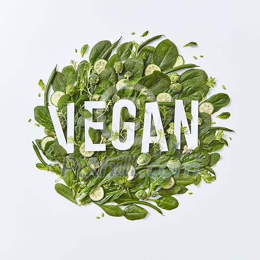 Different green vegetables broccoli, spinach, brussels sprouts, asparagus, mint leaves and cucumber slices on a gray background with space for text. Ingredients for a vegetarian healthy salad Flat lat Different green vegetables broccoli, spinach, brussels sprouts, asparagus, mint leaves and cucumber slices on a gray background with space for text. Ingredients for a vegetarian healthy salad Flat lat