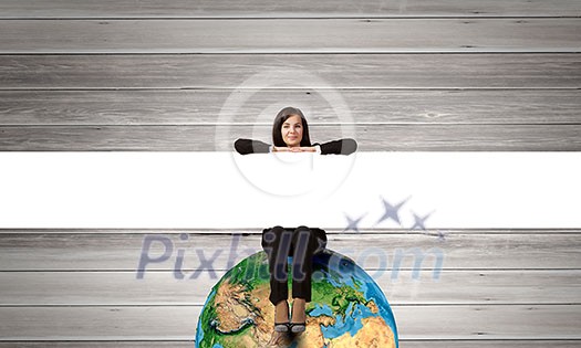 Young woman with blank banner sitting on Earth planet. Elements of this image are furnished by NASA Young woman with blank banner sitting on Earth planet. Elements of this image are furnished by NASA