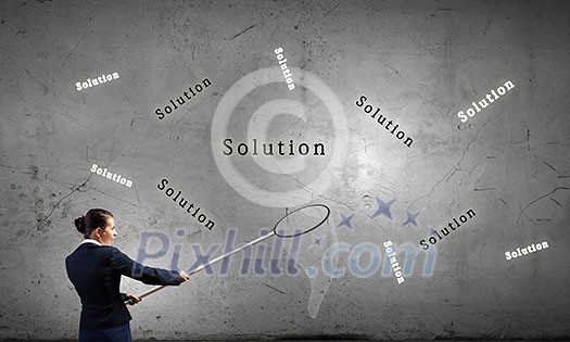 Young businesswoman catching word solution with hoop Young businesswoman catching word solution with hoop