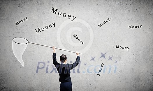 Young businesswoman catching word money with hoop Young businesswoman catching word money with hoop