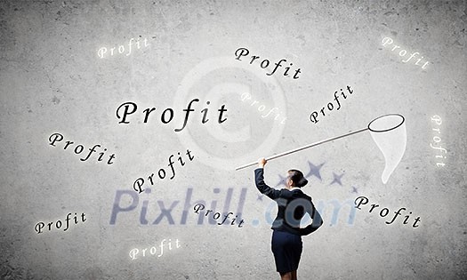 Young businesswoman catching word profit with hoop Young businesswoman catching word profit with hoop