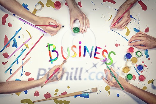 Top view of people hand drawing business creative concept with paints Top view of people hand drawing business creative concept with paints