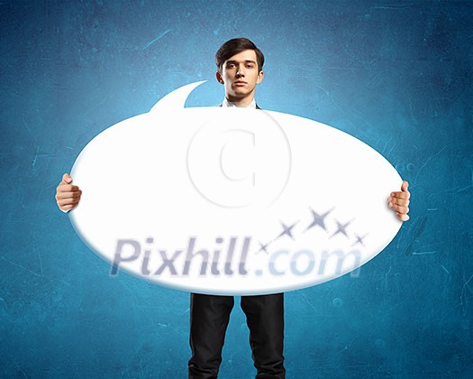 Young businessman showing blank white speech banner. Place for text Young businessman showing blank white speech banner. Place for text