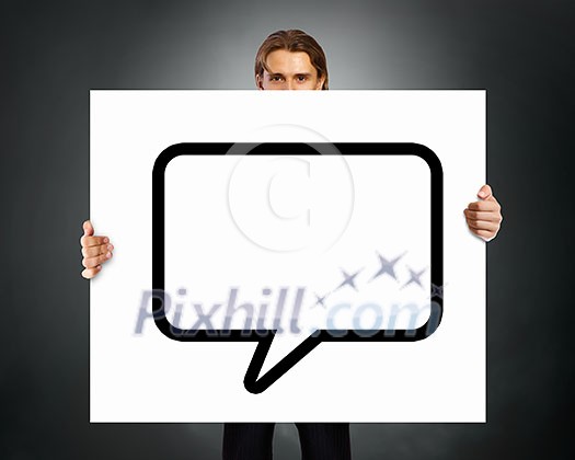 Young businessman showing blank white speech banner. Place for text Young businessman showing blank white speech banner. Place for text