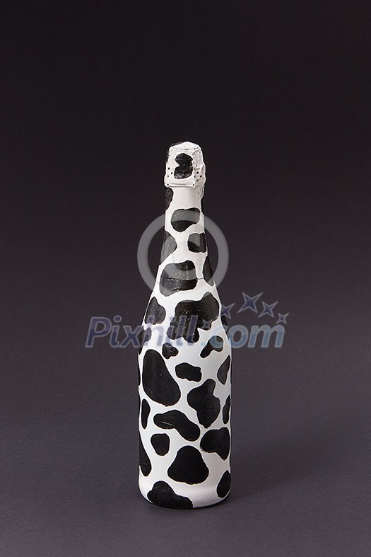 Creative painted wine bottle white with dark spots on a black background, copy space. Minimalism concept. Creative painted wine bottle white with dark spots on a black background, copy space. Minimalism concept.