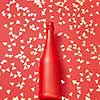 Christmas red painted champane bottle mock up on a holiday background covered shiny small spruces with copy space. Greeting holiday card.