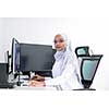 young afro american modern  muslim business woman wearing scarf on creative bright  office workplace with big screen