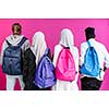 Group Portrait Of University Students african girls wearing traditional islamic scarf veil with plastic pink background