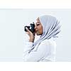 young  african modern muslim woman using retro camera wearing hijab clothes isolated on white background