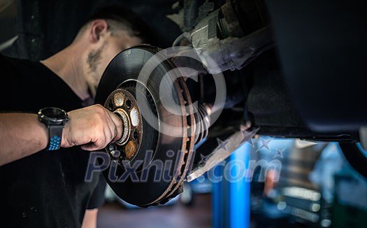 Wheel bearing repair at auto service/garage or workshop by mechanic Wheel bearing repair at auto service/garage or workshop by mechanic