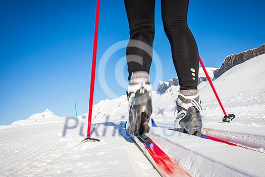 Cross-country skiing: young woman cross-country skiing on a winter day (motion blurred image) Cross-country skiing: young woman cross-country skiing on a winter day (motion blurred image)