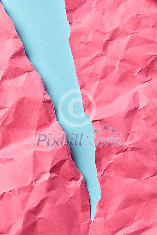 Crumpled hot pink paper on a pastel blue as a handcraft decorative background for your creativity with place for text. Crumpled hot pink paper on a pastel blue as a handcraft decorative background for your creativity with place for text.