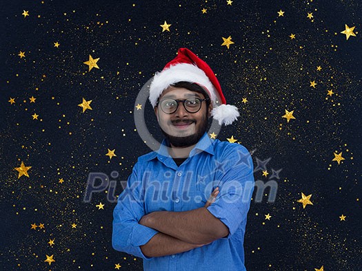 Indian man wearing traditional Santa Claus hat on chalkboard background studio dark-skinned Christmas santa new year party night stars Indian man wearing traditional Santa Claus hat on chalkboard background studio dark-skinned Christmas santa new year party night stars