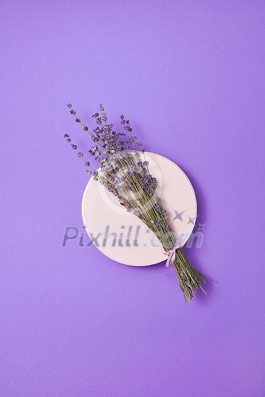 Decorative card with natural dry lavender bouquet on a ceramic round board and lilac background, copy space. Top view. Creeting card Decorative card with natural dry lavender bouquet on a ceramic round board and lilac background, copy space. Top view. Creeting card