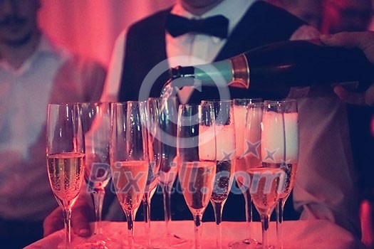 new year office party celebration event Man pours champagne drink in wineglasses new year office party celebration event Man pours champagne drink in wineglasses