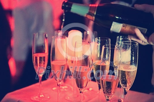 new year office party celebration event Man pours champagne drink in wineglasses new year office party celebration event Man pours champagne drink in wineglasses