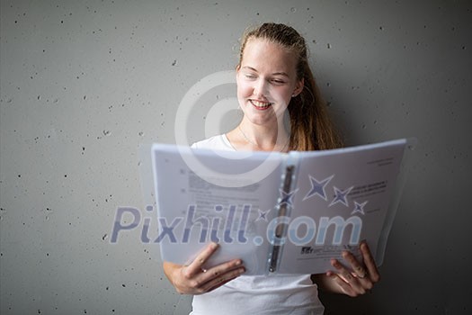 Cute female university/highschool student with books in library Cute female university/highschool student with books in library