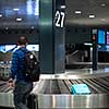 Unclaimed luggage concept - suitcase going around on the conveyor belt at an international airport, at the baggage claim zone - motion blurred image