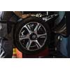 Wheel balancing or repair and change car tire at auto service garage or workshop by mechanic