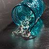 Melting ice in the ovetuned vintage blue glass on a wooden background with shadows, copy space.