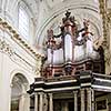 Interior of huge historical catholic cathedral with big organ and places of worship, traditional medieval temple in Europe.