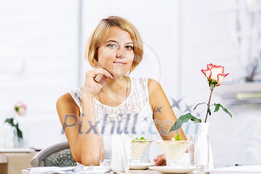 Portrait of young pretty woman sitting at cafe Portrait of young pretty woman sitting at cafe