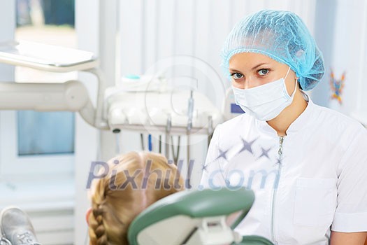Cute smiling girl in at dentist sitting in armchair Cute smiling girl in at dentist sitting in armchair
