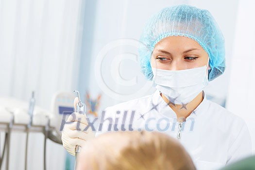 Cute smiling girl in at dentist sitting in armchair Cute smiling girl in at dentist sitting in armchair