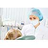 Cute smiling girl in at dentist sitting in armchair