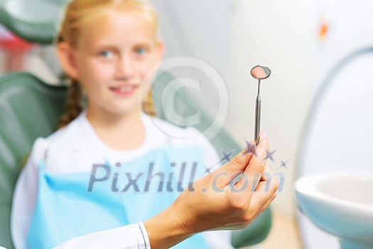 Cute smiling girl in at dentist sitting in armchair Cute smiling girl in at dentist sitting in armchair